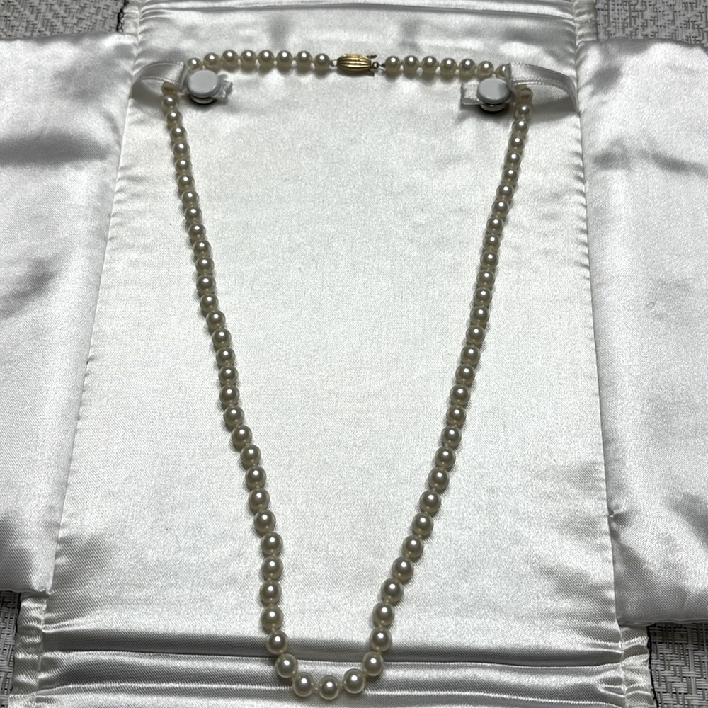 Strand of genuine pearls.